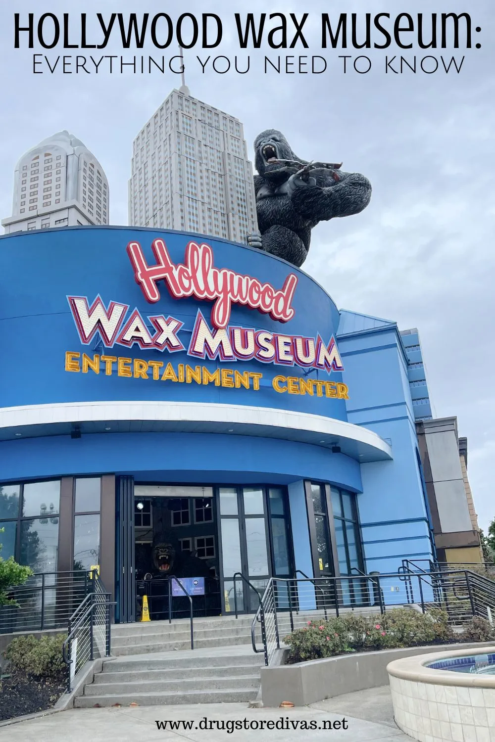 The outside of a building that looks like skyscrapers and has a King Kong hanging off the side of it with the words 