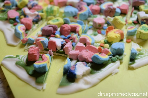 Cut pieces of Lucky Charms Chocolate Bark on a cutting board.