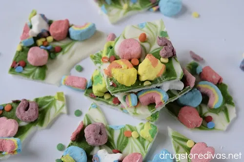 Cut pieces of Lucky Charms Chocolate Bark on a white tray.