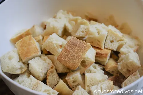 Cubed bread in a white bowl.