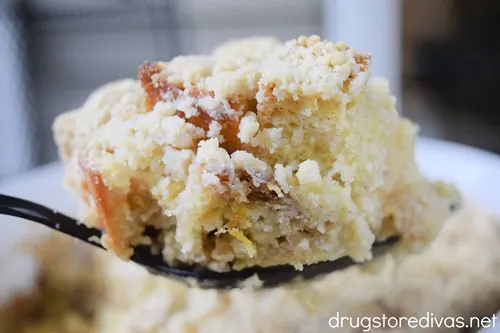 A serving spoon holding French bread casserole.