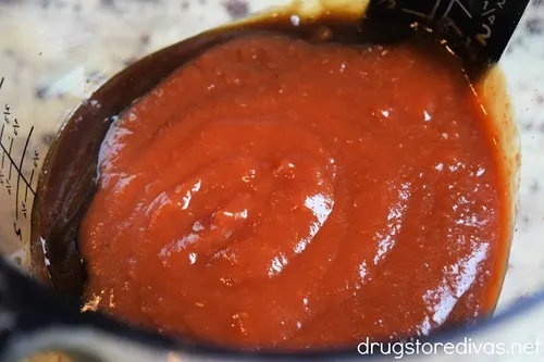 Red sauce in a measuring cup.