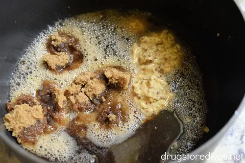 Brown sugar, mustard, and cola soda in a pan.