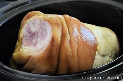 A bone-in ham in a slow cooker.