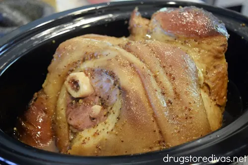 A cooked ham in a slow cooker.