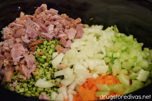 Diced ham, dried peas, chopped carrots, celery, and onion in a slow cooker.