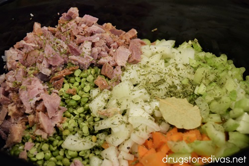 Diced ham, dried peas, chopped carrots, celery, onion, and seasoning in a slow cooker.