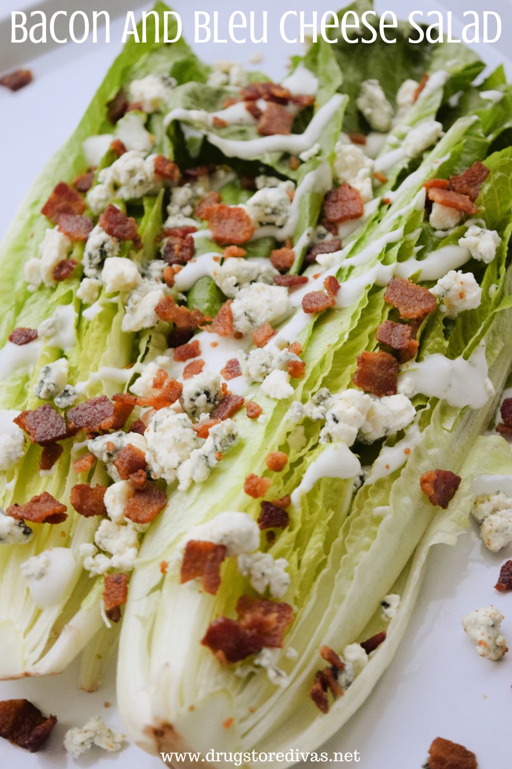 Romaine lettuce on a white tray with bleu cheese crumbles, crumbled bacon, and white dressing on top with the words 