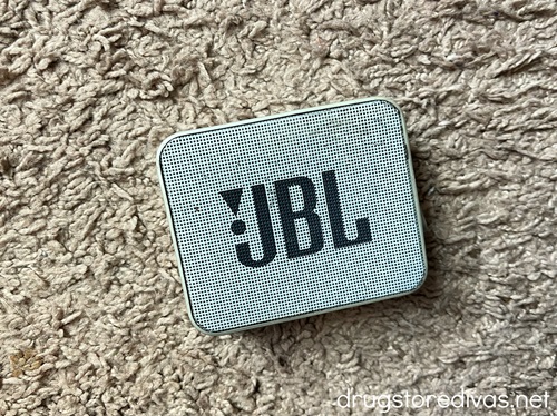 A gray, rectangular JBL portable Bluetooth speaker.