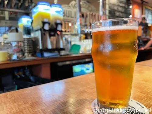 A pint glass of beer on the bar at Bull City Burger and Brewery in Durham, NC.