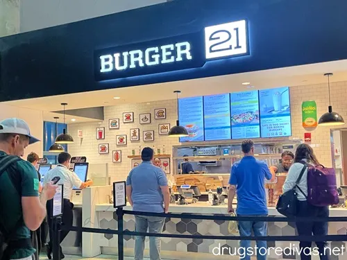 The outside of a Burger21 restaurant in a food court.