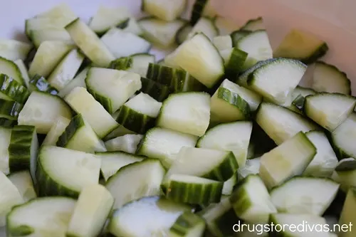 Cucumber pieces in a white bowl.