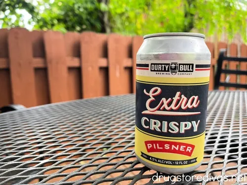 A can of Extra Crispy Pilsner from Durty Bull Beer Company, a brewery in Durham, NC, on a table.