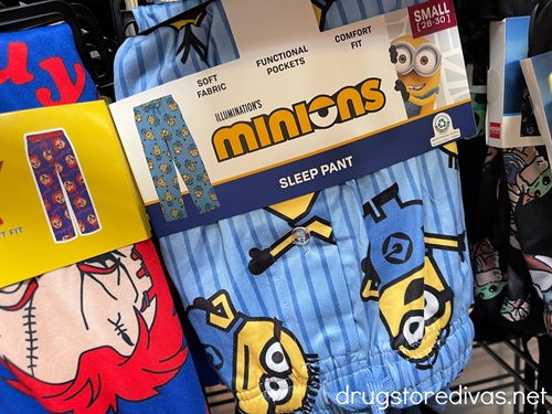 A pair of Minions pajama pants hanging next to a pair of Chucky pajama pants.