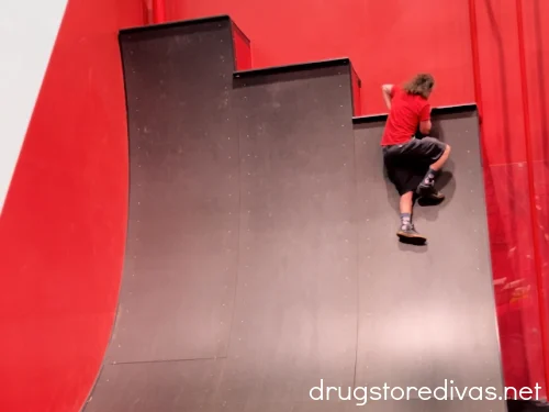 A man on the warped wall at OC Aerial, a ninja warrior gym in Durham, North Carolina.