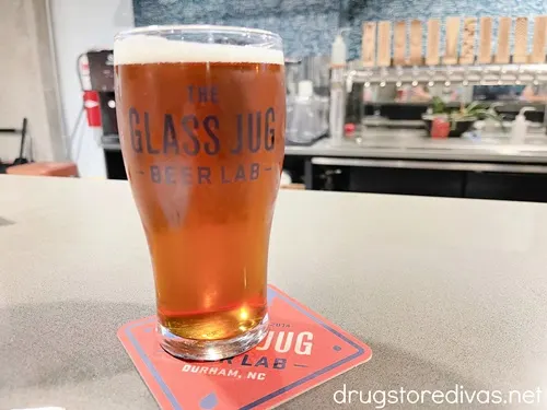 A pint glass of beer on the bar at The Glass Jug Beer Lab in Durham, NC.