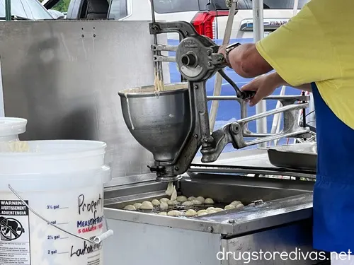 A man working a machine making Greek doughnuts at the Wilmington Greek Festival.