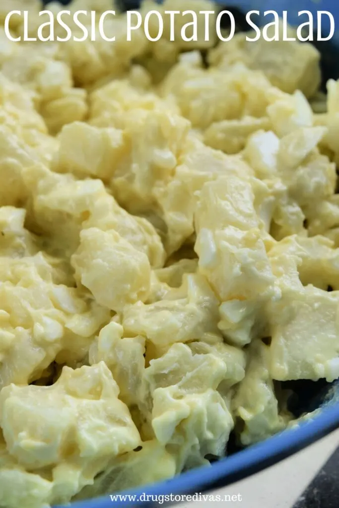A blue bowl filed with classic American potato salad with the words "Classic Potato Salad" digitally written on top.