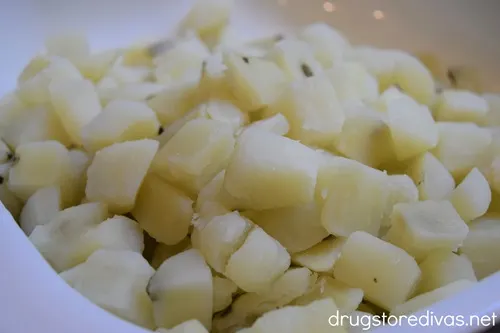 Cooked, diced potato pieces in a white bowl.