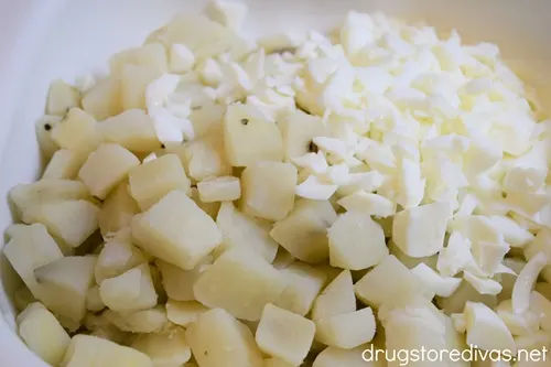 Diced potatoes and chopped egg whites in a white bowl.