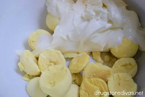 Egg yolks and mayonnaise in a white bowl.