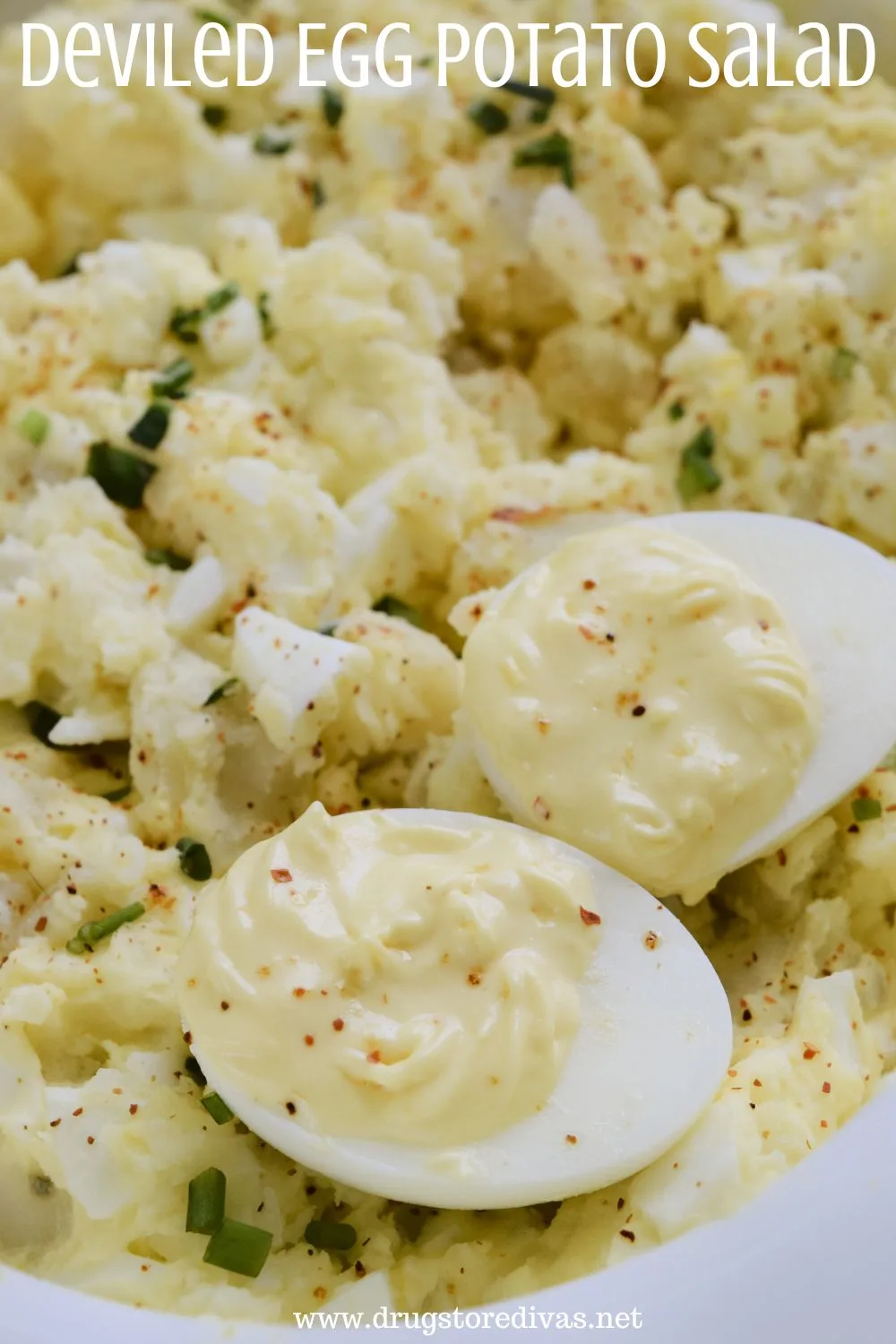 Two deviled eggs on top of potato salad with the words "Deviled Egg Potato Salad" digitally written on top.