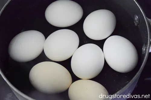 Eight eggs in a pot of water.