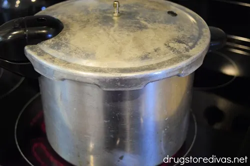 A pressure cooker on a stove top.