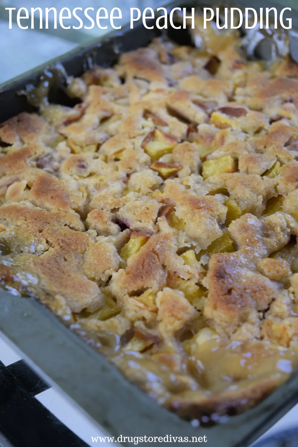 A peach cake in a silver pan with the words 