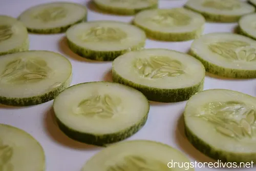 Cucumber slices on a white serving tray.