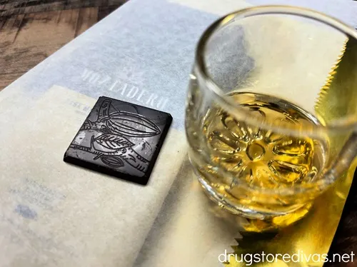 A square of chocolate next to a glass with a sip of whiskey in Montadero Chocolate in Caguas, Puerto Rico.