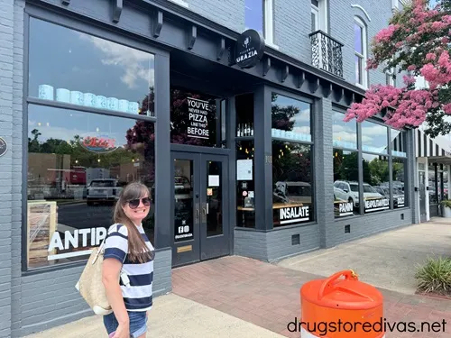 A woman standing outside Pizzeria Grazia in Aberdeen, NC.