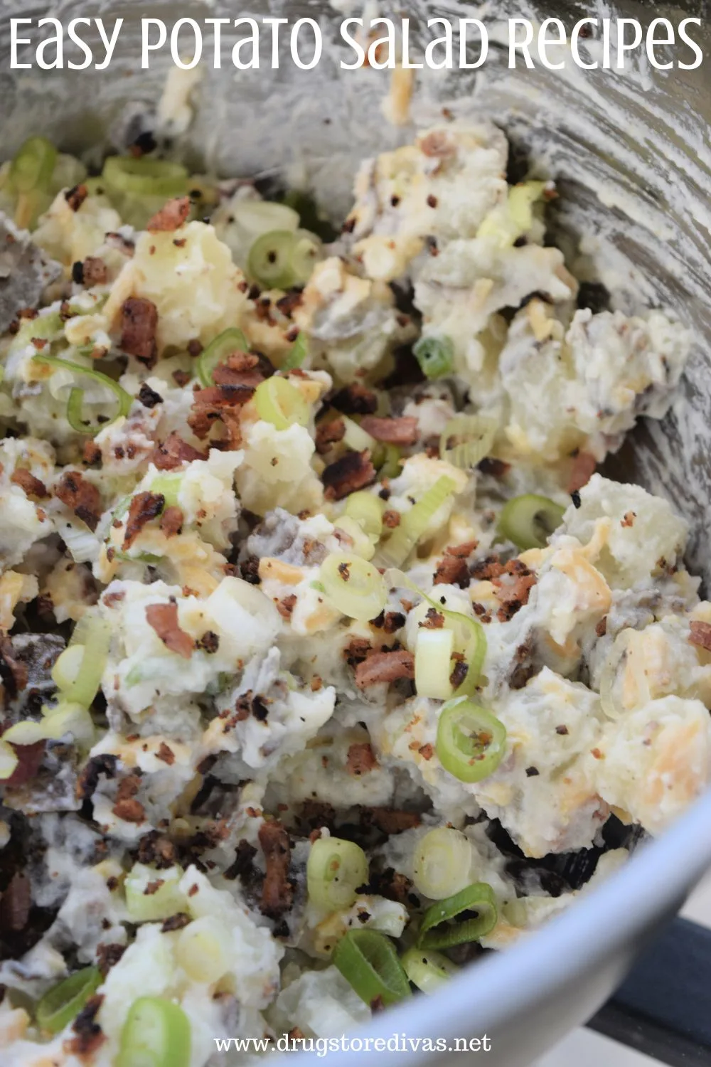 Loaded potato salad in a metal bowl with the words 