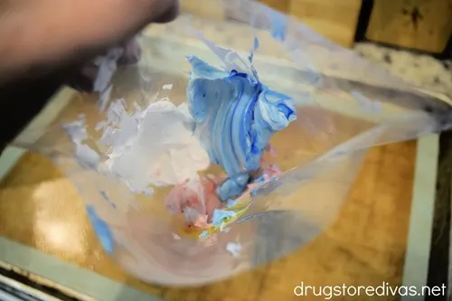 Red, white, and blue meringue in a piping bag.