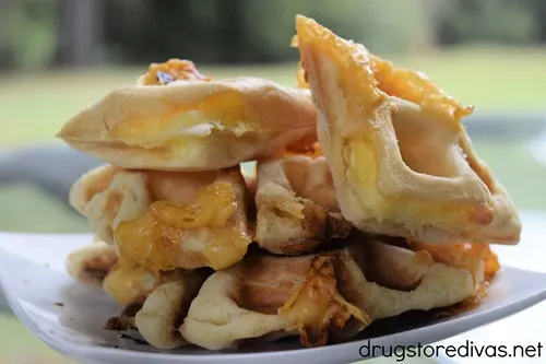 Pieces of cooked stuffed waffle on a plate.