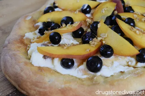 A Peach, Blueberry And Goat Cheese Pizza.