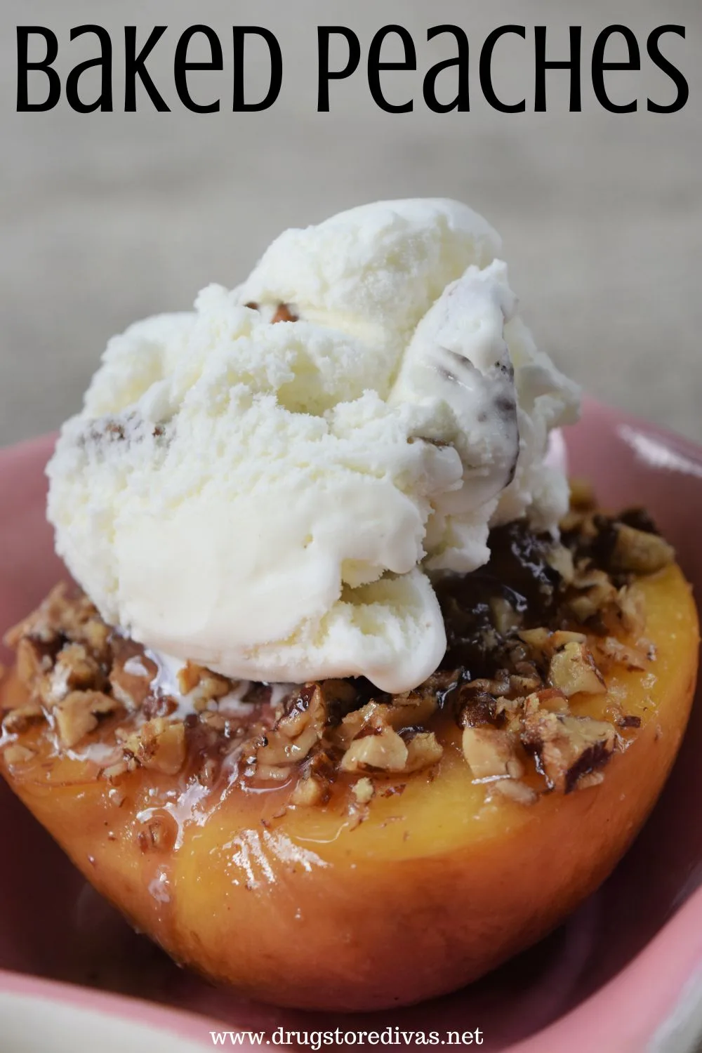 A baked peach in a pink plate with pecans and ice cream on top and the words 
