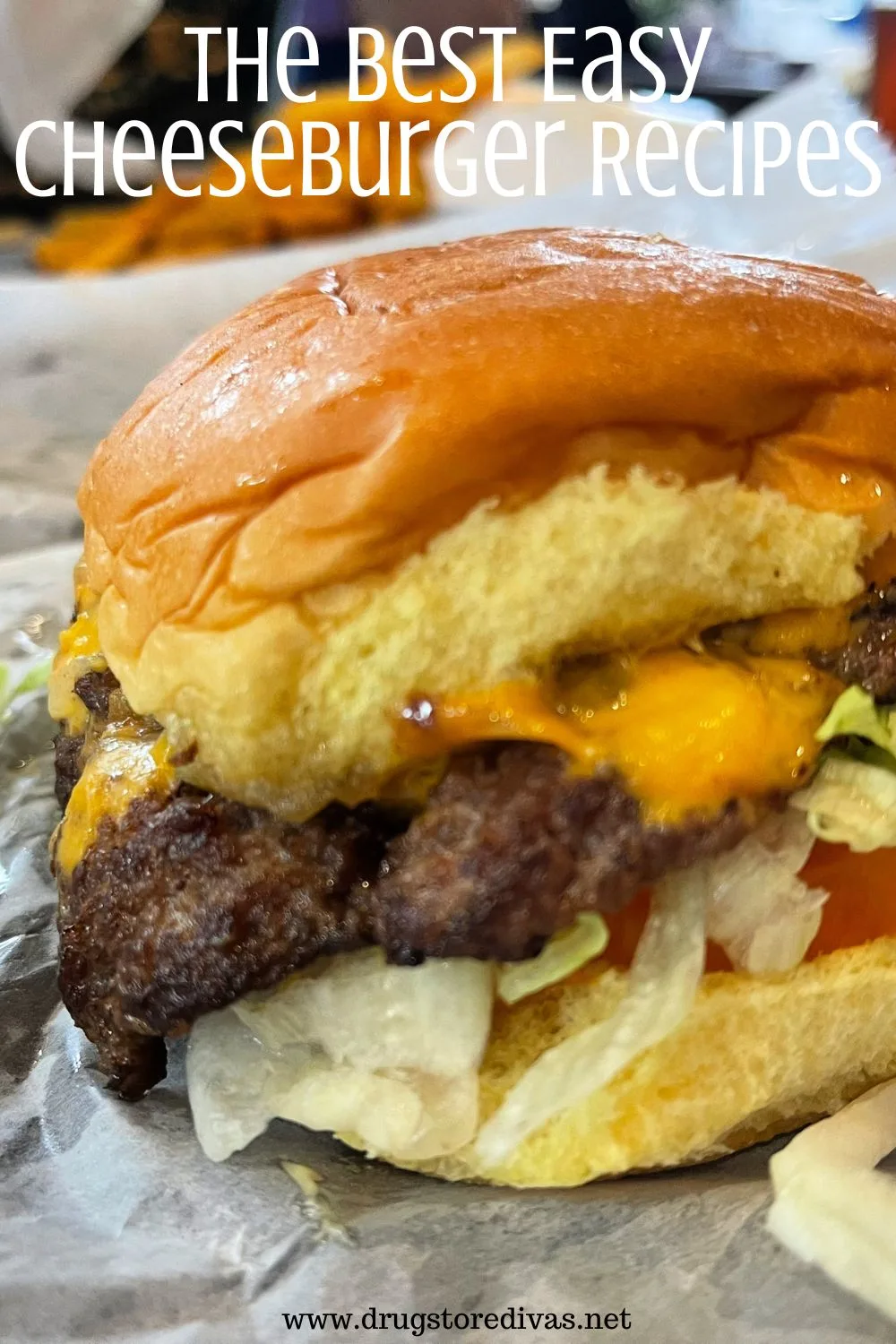 A cheeseburger on parchment paper with the words