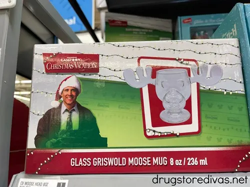 A moose-shaped glass mug from National Lampoon's Christmas Vacation in a box on a shelf.