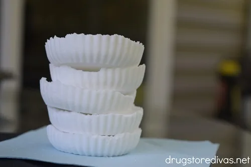 Five shower steamers stacked on a blue napkin on a table.