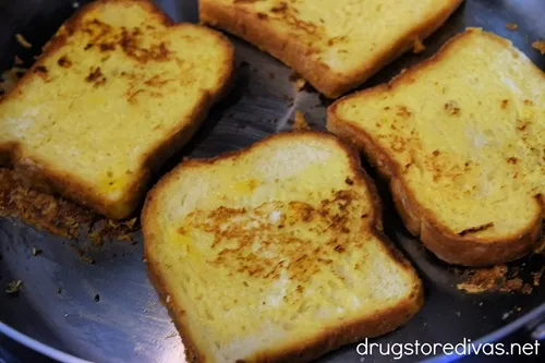 Four pieces of French bread in a pan.