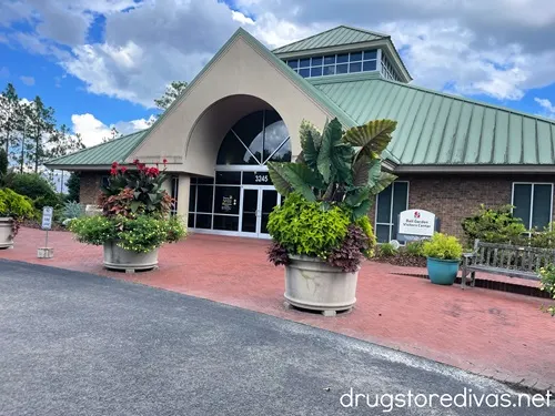 A building with large potted flowers outside.