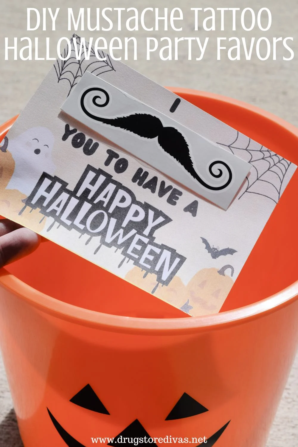 A DIY Halloween card going into an orange pumpkin bucket with the words 