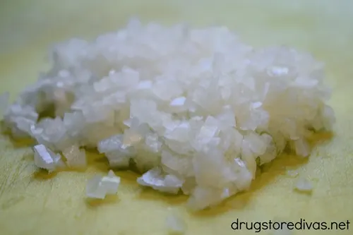 Finely chipped onions on a cutting board.
