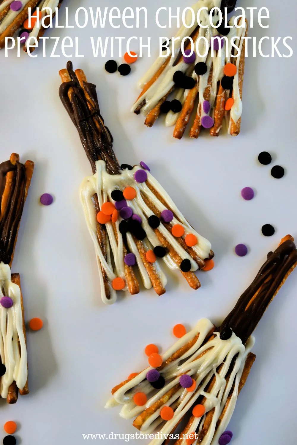 Chocolate covered pretzels that look like brooms on a white tray with the words 