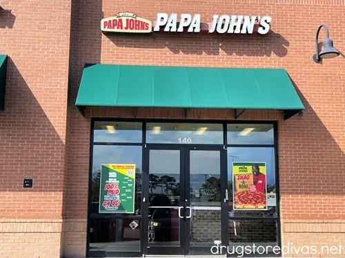 The outside of a Papa John's restaurant.