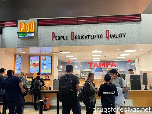 The outside of a PDQ Chicken restaurant that's located in the Tampa Airport.
