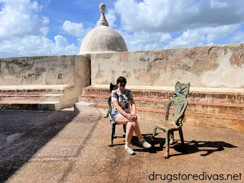 A woman sitting on a cat-shaped chair in San Juan, Puerto Rico.