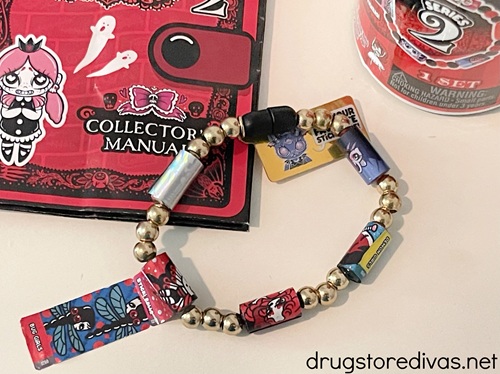 A Sticki Rolls sticker bracelet with its packaging nearby.