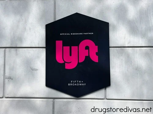 A black sign advertising the ride share company Lyft.